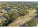 Aerial view of a community with lush green areas, a lake, and golf course at 3505 Tarpon Woods Blvd # K403, Palm Harbor, FL 34685