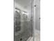 Modern bathroom with marble shower and patterned tile at 3505 Tarpon Woods Blvd # K403, Palm Harbor, FL 34685