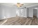 Main bedroom with vinyl flooring and barn door to en-suite bathroom at 3505 Tarpon Woods Blvd # K403, Palm Harbor, FL 34685