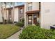 Exterior view of condo building with walkway and landscaping at 3505 Tarpon Woods Blvd # K403, Palm Harbor, FL 34685