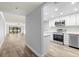 Open concept kitchen with white cabinets and stainless steel appliances at 3505 Tarpon Woods Blvd # K403, Palm Harbor, FL 34685