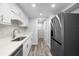 Modern kitchen with white cabinets, stainless steel appliances and quartz countertops at 3505 Tarpon Woods Blvd # K403, Palm Harbor, FL 34685