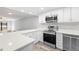 Modern kitchen with white cabinets, stainless steel appliances and quartz countertops at 3505 Tarpon Woods Blvd # K403, Palm Harbor, FL 34685