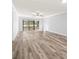 Spacious living room featuring vinyl flooring and access to patio at 3505 Tarpon Woods Blvd # K403, Palm Harbor, FL 34685