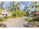 Private backyard with gravel, lush landscaping, and fence at 4595 Northwood Ter, Sarasota, FL 34234