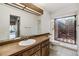 Updated bathroom with wood vanity, shower, and large window at 4595 Northwood Ter, Sarasota, FL 34234