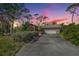 Attractive ranch home exterior at sunset, showcasing landscaping and a large yard at 4595 Northwood Ter, Sarasota, FL 34234