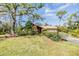 Ranch home with a spacious front yard, lush landscaping, and a park-like setting at 4595 Northwood Ter, Sarasota, FL 34234