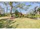 Ranch home with a spacious front yard, lush landscaping, and a park-like setting at 4595 Northwood Ter, Sarasota, FL 34234