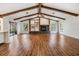 Open living room featuring hardwood floors and a fireplace at 4595 Northwood Ter, Sarasota, FL 34234