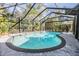 Inviting screened pool area with a freeform pool and paved deck at 4595 Northwood Ter, Sarasota, FL 34234