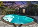 Relaxing kidney-shaped pool with a screened enclosure at 4595 Northwood Ter, Sarasota, FL 34234