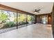 Spacious screened porch with tile flooring and ceiling fan at 4595 Northwood Ter, Sarasota, FL 34234