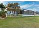 Landscaped backyard with white fence and canal view at 805 Islebay Dr, Apollo Beach, FL 33572