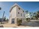 Two-story house with gray siding, elevated foundation, and blue door at 820 Gulf Blvd # S 1-3, Indian Rocks Beach, FL 33785