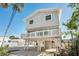 Two-story elevated house, gray siding, white balcony and railings at 820 Gulf Blvd # S 1-3, Indian Rocks Beach, FL 33785