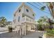 Two-story house with gray siding, elevated foundation, and balcony at 820 Gulf Blvd # S 1-3, Indian Rocks Beach, FL 33785