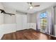 Bright bedroom with wood flooring and arched window at 8436 Red Roe Dr, New Port Richey, FL 34653