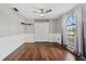 Spacious bedroom with wood flooring and large window at 8436 Red Roe Dr, New Port Richey, FL 34653