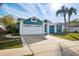 Exterior of a teal house with a white garage door at 8436 Red Roe Dr, New Port Richey, FL 34653