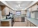 Kitchen with stainless steel appliances and light wood cabinets at 8436 Red Roe Dr, New Port Richey, FL 34653