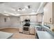 Kitchen features stainless steel appliances and light wood cabinets at 8436 Red Roe Dr, New Port Richey, FL 34653