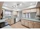 L shaped kitchen with stainless steel appliances and light wood cabinets at 8436 Red Roe Dr, New Port Richey, FL 34653