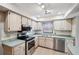 Bright kitchen with stainless steel appliances and light wood cabinets at 8436 Red Roe Dr, New Port Richey, FL 34653