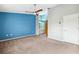 Main bedroom with blue accent wall and carpet flooring at 8436 Red Roe Dr, New Port Richey, FL 34653
