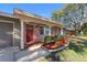Front entrance with red door, brick facade, and nicely landscaped area at 1340 Williams Dr, Clearwater, FL 33764
