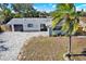 Updated home exterior with modern gray siding and paver driveway at 1346 Hill Dr, Largo, FL 33770