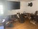 Living room with large TV, hardwood floors, and various furniture at 1608 S 45Th St, Tampa, FL 33619