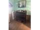 Living room with antique organ and hardwood floors; shows signs of needing renovations at 1608 S 45Th St, Tampa, FL 33619