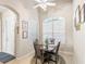 Bright dining area with stained glass window and seating for four at 2290 Sifield Greens Way, Sun City Center, FL 33573