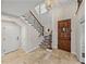 Bright entryway with a grand staircase and tiled floors at 307 Harbor View Ln, Largo, FL 33770