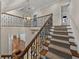 Elegant staircase with wrought iron railing and chandelier at 307 Harbor View Ln, Largo, FL 33770