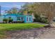 Cute light blue house with a well-manicured lawn and driveway at 6210 S Harold Ave, Tampa, FL 33616