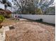 Large backyard with a patio and white vinyl fence at 700 16Th Nw St, Largo, FL 33770