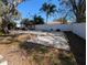 Large backyard with two concrete pads and a white vinyl fence at 700 16Th Nw St, Largo, FL 33770