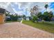 Landscaped backyard with a brick patio at 7211 Waycross Ave, Tampa, FL 33619