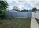 View of backyard with metal fence and gate at 7211 Waycross Ave, Tampa, FL 33619
