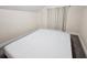 Spacious bedroom with a large mattress and window with curtains at 7211 Waycross Ave, Tampa, FL 33619