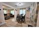 Bright dining area with tile floors and view into living room at 7211 Waycross Ave, Tampa, FL 33619
