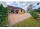 Cute yellow house with brick paver driveway at 7211 Waycross Ave, Tampa, FL 33619