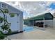 Green metal carport and a gray storage shed in the backyard at 7211 Waycross Ave, Tampa, FL 33619