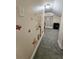 Light-colored hallway with room access, showing gray carpeting and wall decals at 7211 Waycross Ave, Tampa, FL 33619