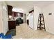 Open kitchen with dark wood cabinets and granite countertops at 7211 Waycross Ave, Tampa, FL 33619