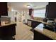 Well-lit kitchen with granite countertops and stainless steel appliances at 7211 Waycross Ave, Tampa, FL 33619