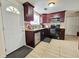 Kitchen features dark wood cabinets, granite counters, and modern appliances at 7211 Waycross Ave, Tampa, FL 33619