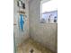 Clean shower with tile surround and storage at 7211 Waycross Ave, Tampa, FL 33619